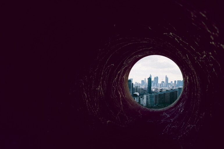 Photo of a dark hole leading up to Canary Wharf, London (the banking district)