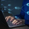 Photo of a man typing on a laptop with an overlay image that looks like blocks inside a distributed ledger
