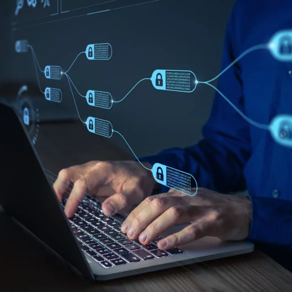 Photo of a man typing on a laptop with an overlay image that looks like blocks inside a distributed ledger