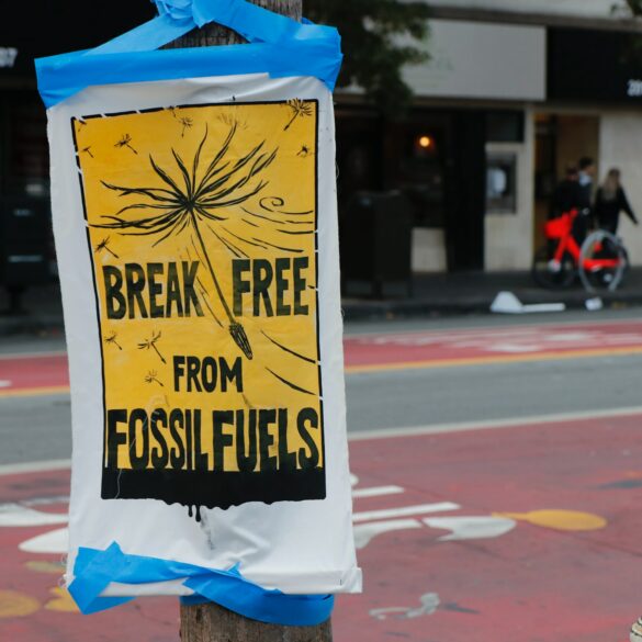 Poster in a city street that writes "break free from fossil fuels."