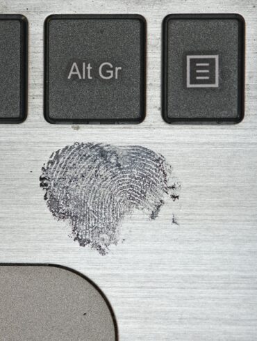 Photo of a clear fingerprint mark left on a Laptop surface with black-ink