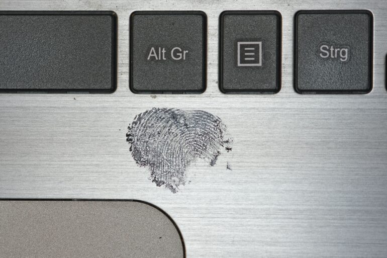 Photo of a clear fingerprint mark left on a Laptop surface with black-ink