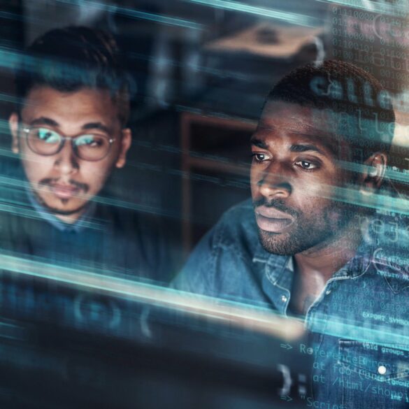 Photo of two men coding on a computer screen with an overlay over the image showing codes