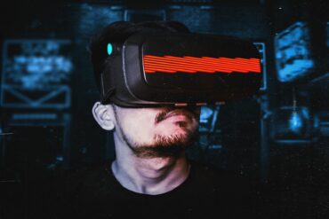 Photo of a man wearing a virtual reality (VR) headset, depicting an increasing trend towards the metaverse