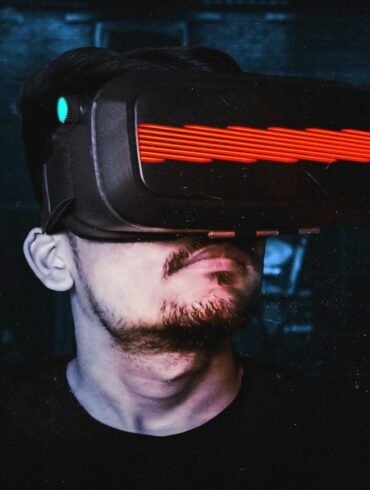 Photo of a man wearing a virtual reality (VR) headset, depicting an increasing trend towards the metaverse