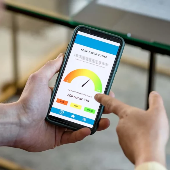 Photo of two people looking at credit scores on the phone