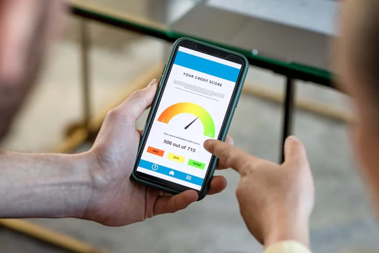 Photo of two people looking at credit scores on the phone