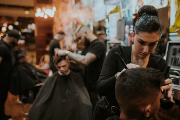 People getting haircuts at a barbershop