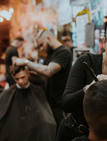 People getting haircuts at a barbershop
