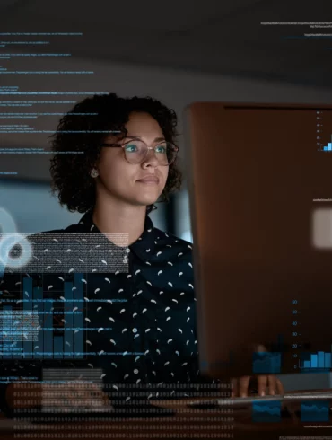 Photo of a woman looking at a laptop with an overlay in the image of data