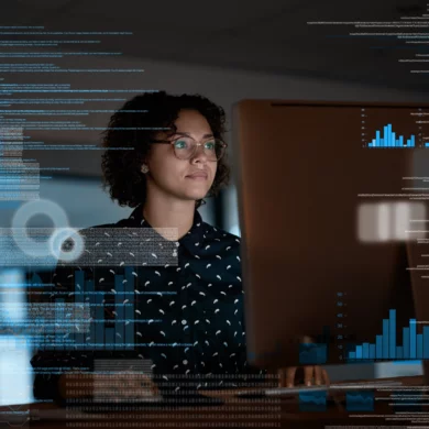 Photo of a woman looking at a laptop with an overlay in the image of data
