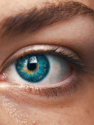 human eye with mixed colours between blue and yellow, looking slightly artificial