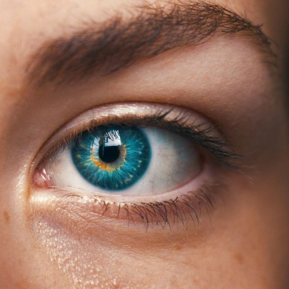 human eye with mixed colours between blue and yellow, looking slightly artificial