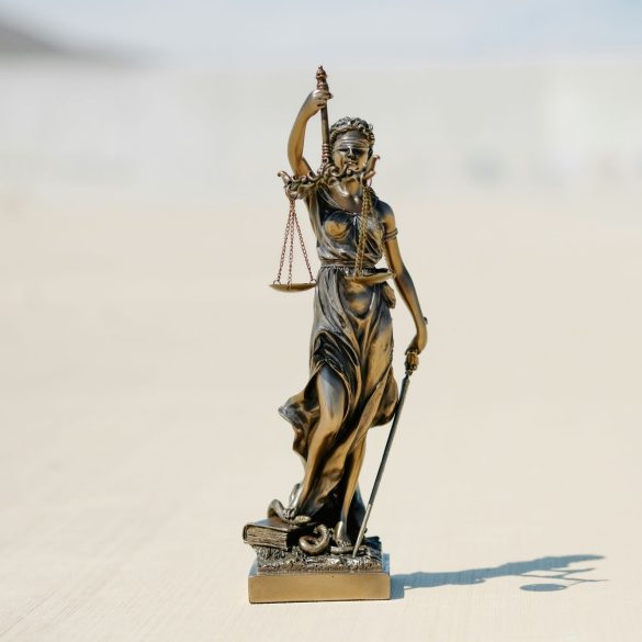 A classic symbol of the legal system, representing fairness, objectivity (blindfold), and the power of the law (sword).